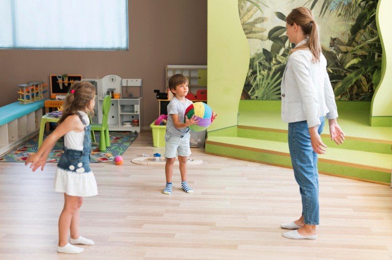Child development specialist engaging children in a play-based activity to support growth and developmental milestones