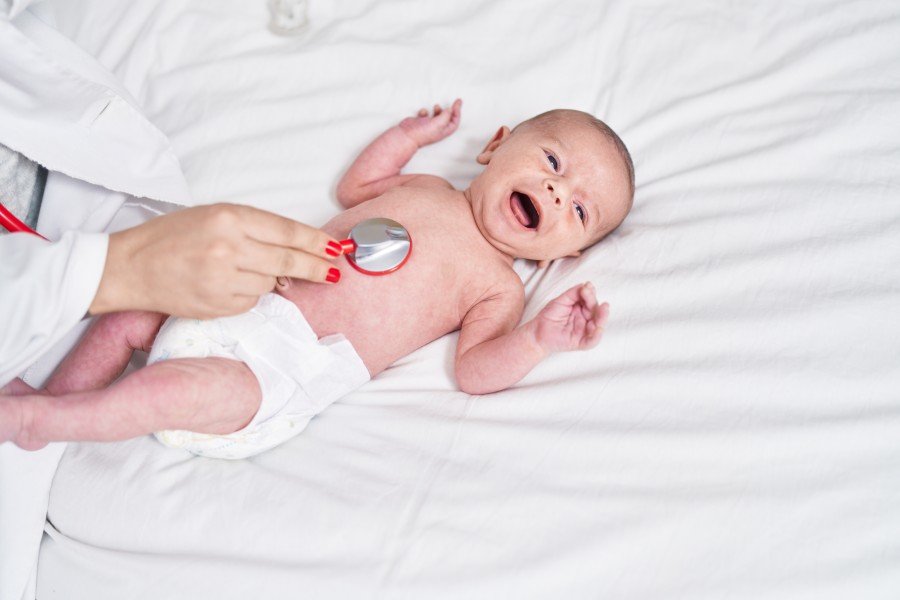 Newborn baby undergoing a heart examination with a stethoscope during a neonatal cardiac check-up at a Neonatal Echo Centre.