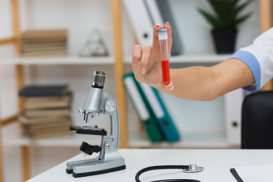 Doctor holding a blood sample tube for diagnostic testing