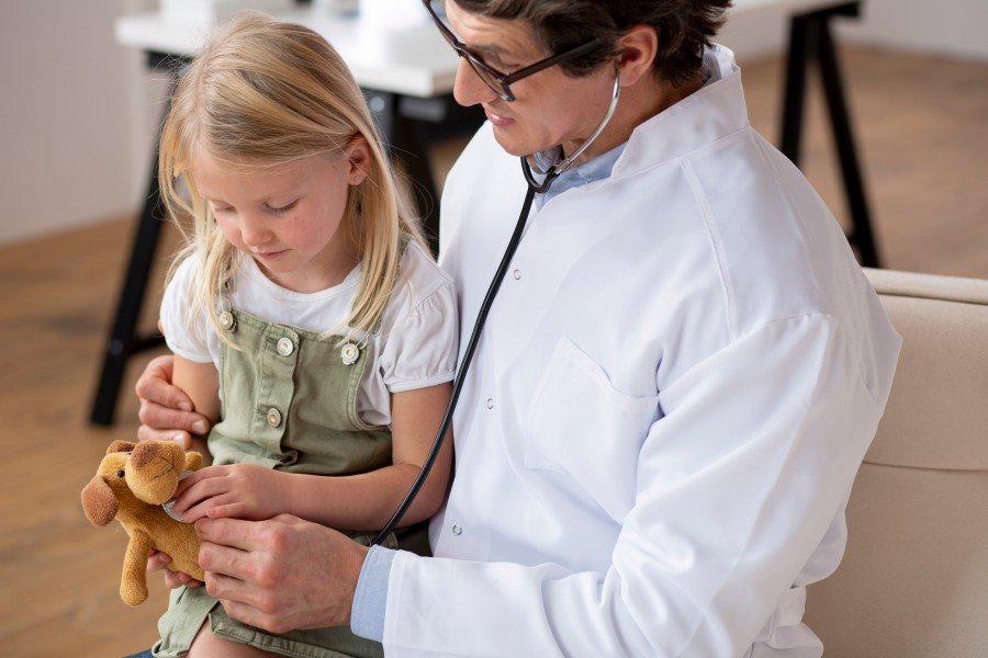 Pediatrician examining a young girl during a child health check-up